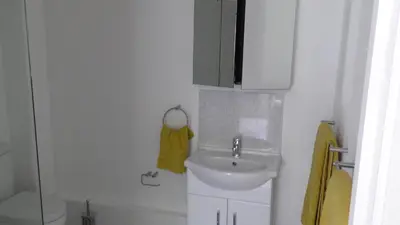 a small bathroom with a sink and a toilet at The Lodge Greatwood in Ipswich