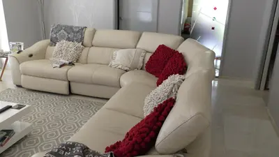 a white couch with pillows on it in a living room at The Lodge Greatwood in Ipswich