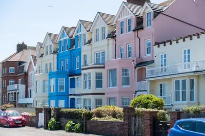 a row of colorful houses in a street at Stoney Beach - Aldeburgh Coastal Cottages in Aldeburgh