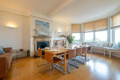 a dining room with a table and chairs at Stoney Beach - Aldeburgh Coastal Cottages in Aldeburgh