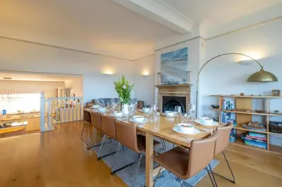 a large dining room with a long table and chairs at Stoney Beach - Aldeburgh Coastal Cottages in Aldeburgh