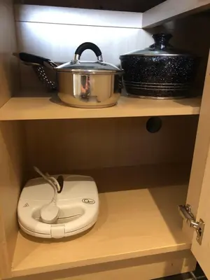 a slow cooker on a shelf in a kitchen at Adam And Eve Street Apartment in Cambridge