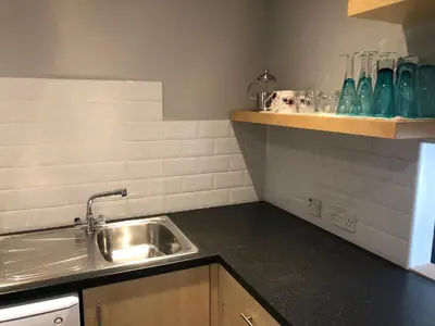 a kitchen with a sink and a counter top at Adam And Eve Street Apartment in Cambridge