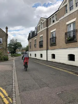 a red bike parked on the side of a street at Adam And Eve Street Apartment in Cambridge