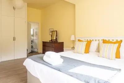 a bedroom with a large white bed and a mirror at Willow House in Knodishall, Sleeps 7 - Only a short drive from Aldeburgh, Thorpeness & Snape Maltings - Managed by Aldeburgh Coastal Cottages in Aldringham