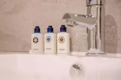 three bottles ofodorizers sitting on top of a sink at 8 Deben Wharf, Woodbridge in Woodbridge