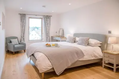 a bedroom with a bed with a tray of fruit on it at 8 Deben Wharf, Woodbridge in Woodbridge
