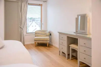 a bedroom with a desk and a chair and a window at 8 Deben Wharf, Woodbridge in Woodbridge