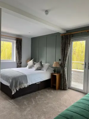a bedroom with a large bed and a window at The Three Pickerels in Mepal