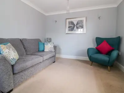 a living room with a couch and a chair at The Hoist in Ely