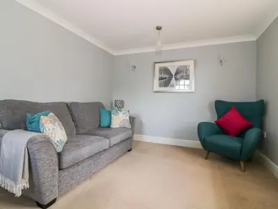 a living room with a couch and a chair at The Hoist in Ely