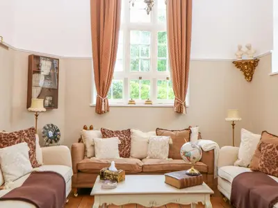 a living room with two couches and a table at The Old School in Wereham