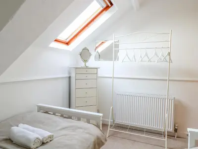 a attic bedroom with a bed and a skylight at The Old School in Wereham