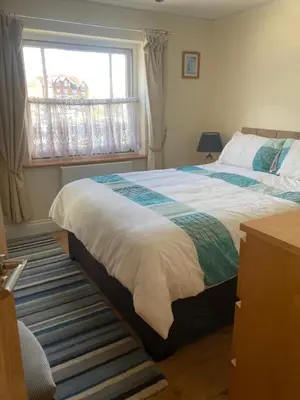 a bedroom with two beds and a window at Broxbourne Two-Bedroom Apartment Close To Amenities in Hoddesdon