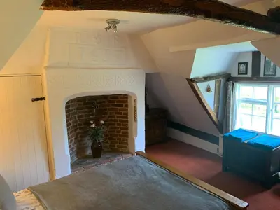 a living room with a brick fireplace in a house at Beaumont's Cottage in Cambridge