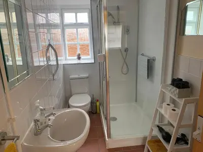 a bathroom with a sink and a toilet and a shower at Beaumont's Cottage in Cambridge