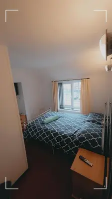 a bedroom with a large bed with a window at The Horse and Groom Guest House in Swaffham
