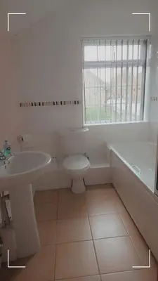 a bathroom with a sink and a toilet and a tub at The Horse and Groom Guest House in Swaffham