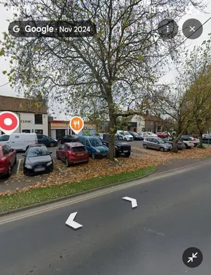 a street with cars parked in a parking lot at The Horse and Groom Guest House in Swaffham