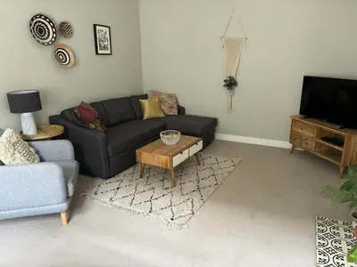 a living room with a couch and a coffee table at Old Green Chambers spacious town centre apartment with free parking! in St Ives