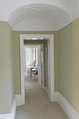 a hallway with green walls and a white ceiling at Old Green Chambers spacious town centre apartment with free parking! in St Ives