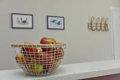 a basket of apples sitting on top of a counter at Old Green Chambers spacious town centre apartment with free parking! in St Ives