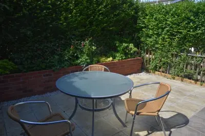 a blue table and chairs on a patio at The Alms House in Thetford