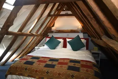 a bedroom with a bed in an attic at The Alms House in Thetford