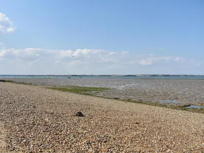 a rocky beach with the ocean in the background at Rainbows End in Saint Lawrence