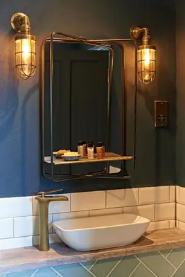 a bathroom with a sink and a large mirror at The Lodge Duxford in Duxford