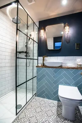 a bathroom with a toilet and a mirror at The Lodge Duxford in Duxford