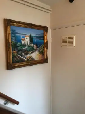 a painting hanging on a wall next to a door at Homely & Cosy 3 Bed Birch Close House with Free Parking, Garden & Sleeps 8 in Cambridge