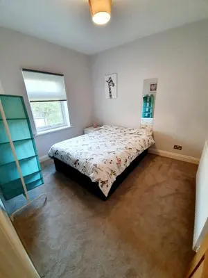 a bedroom with a bed and a window at Beautiful 3 Bedroom House at the Sea Front - Amazing Location in Southend-on-Sea