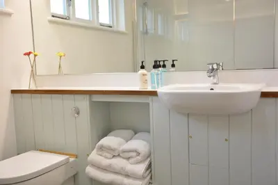a white bathroom with a sink and a toilet at Yew Tree Farm Stable, Worlingworth in Worlingworth