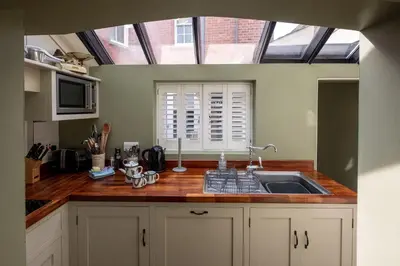 a kitchen counter with a sink and a window at Bloom Cottage in Aldeburgh
