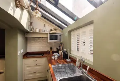 a kitchen with a sink and a skylight at Bloom Cottage in Aldeburgh