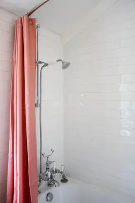 a shower with a pink shower curtain in a bathroom at Bloom Cottage in Aldeburgh