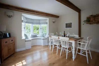 a dining room with a table and chairs and a window at Westgate Lodge at Dedham in Dedham