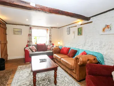 a living room with a couch and a table at Garden House in Thetford
