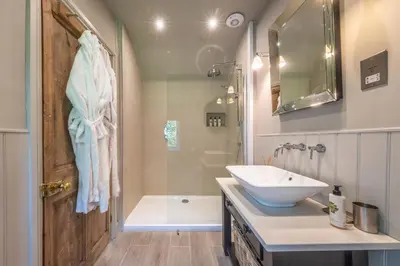 a bathroom with a sink and a shower and a tub at Church Farm B&B Suffolk in Great Welnetham