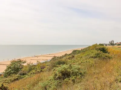 a view of a beach with people in the water at Sea View Cottage in Frinton-on-Sea