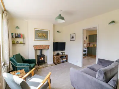 a living room with a couch and a fireplace at Sea View Cottage in Frinton-on-Sea