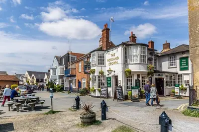 a group of buildings on a street in a town at Cosy Cottage Fireplace Patio Pet Train Stn in Wivenhoe