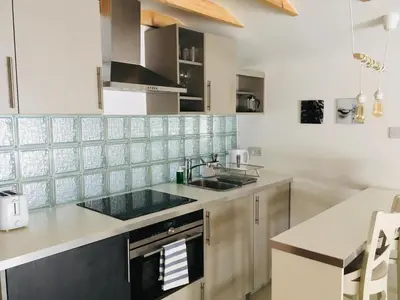 a kitchen with a sink and a counter at Modern self contained tiny home with patio in Loughton