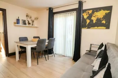 a dining room with a table and a couch at Pet Friendly Home in Chelmsford-Hot Tub-Sleeps 6 in Latchingdon and Snoreham