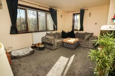 a living room with a couch and a table at Pet Friendly Home in Chelmsford-Hot Tub-Sleeps 6 in Latchingdon and Snoreham