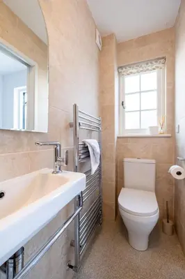 a bathroom with a sink and a toilet at 5 The Haven in Thorpeness