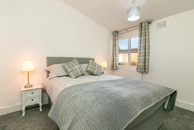 a bedroom with a bed and a window at Hillcrest Lodge in Stevenage