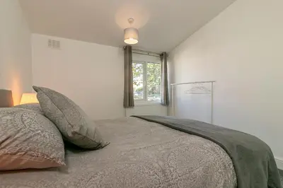 a bedroom with a bed with pillows and a window at Hillcrest Lodge in Stevenage
