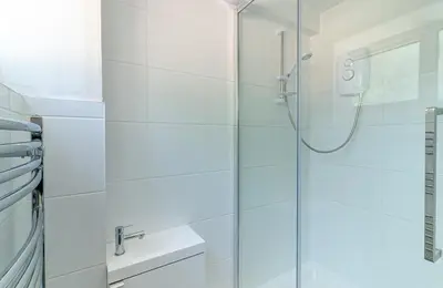 a bathroom with a shower with a glass door at Hillcrest Lodge in Stevenage